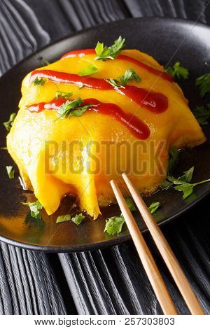 Delicious Omurice Omelette Stuffed With Rice, Chicken And Vegetables Served On A Plate. Vertical