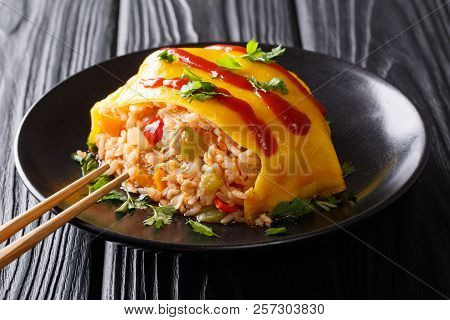 Japanese Omurice Omelette With Rice, Chicken And Vegetables Close-up. Horizontal