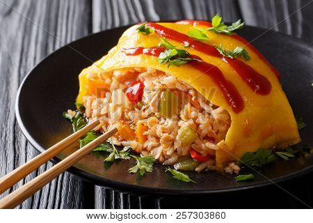 Japanese Cuisine: Omurice With Rice, Chicken And Vegetables Close-up. Horizontal