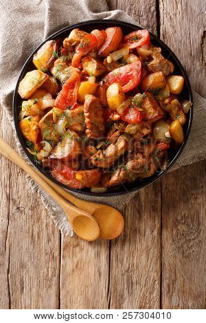 Fried Meat With Potatoes, Tomatoes, Herbs And Spices Close-up On A Frying Pan. Georgian Cuisine. Ver