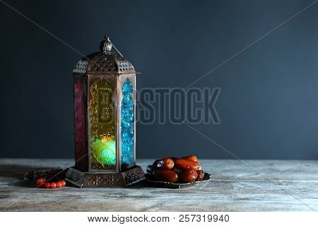 Muslim Lamp, Dates And Misbaha On Wooden Table. Fanous As Ramadan Symbol