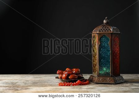 Muslim Lamp, Dates And Misbaha On Wooden Table. Fanous As Ramadan Symbol