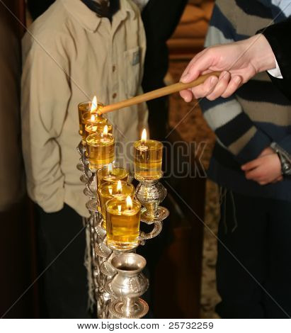 Rabi lights a candle in the Jewish holiday of Hanukkah
