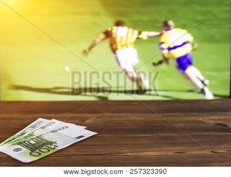 Euro Money On The Background Of A Tv On Which The Sport Is Shown In The Game Of Hurling, Sports Bett