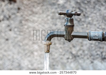 A Tap From A Drinking Water Fountain In The Village Of Santa Fosca, In The Italian Dolomites On A Su
