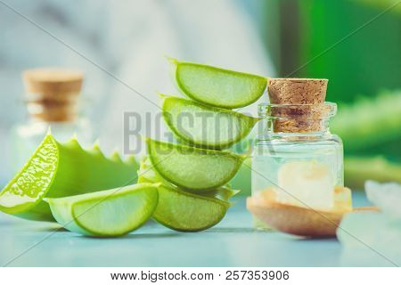 Aloe Vera Extract In A Small Bottle And Pieces On The Table. Selective Focus.