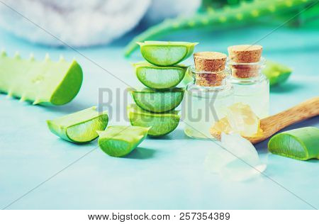 Aloe Vera Extract In A Small Bottle And Pieces On The Table. Selective Focus.