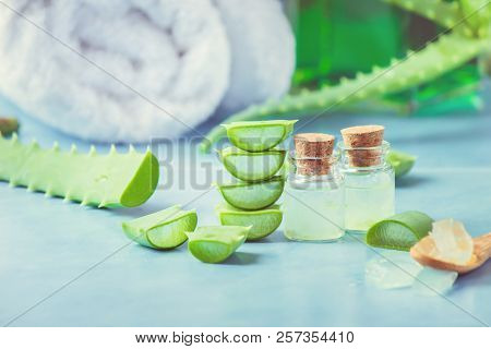 Aloe Vera Extract In A Small Bottle And Pieces On The Table. Selective Focus.