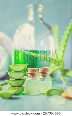 Aloe Vera Extract In A Small Bottle And Pieces On The Table. Selective Focus.