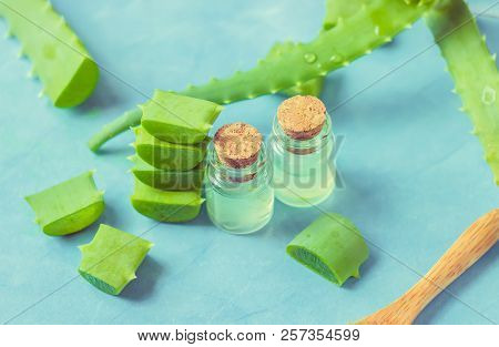 Aloe Vera Extract In A Small Bottle And Pieces On The Table. Selective Focus.