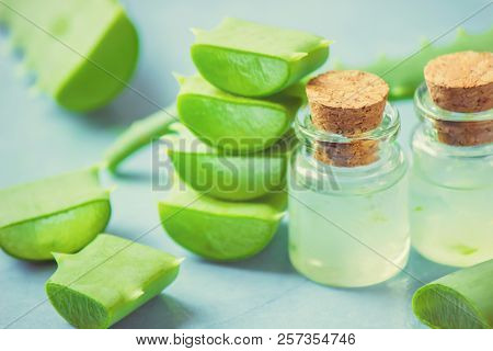 Aloe Vera Extract In A Small Bottle And Pieces On The Table. Selective Focus.