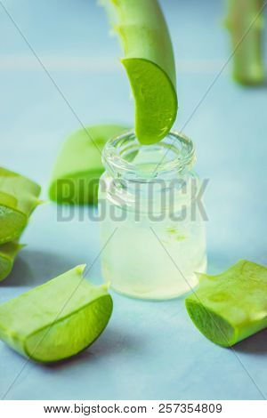 Aloe Vera Extract In A Small Bottle And Pieces On The Table. Selective Focus.