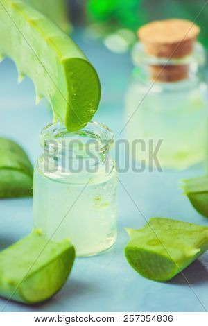 Aloe Vera Extract In A Small Bottle And Pieces On The Table. Selective Focus.