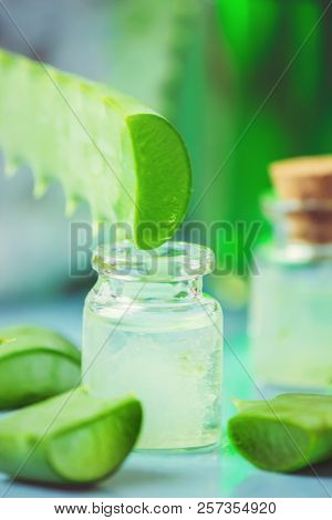 Aloe Vera Extract In A Small Bottle And Pieces On The Table. Selective Focus.
