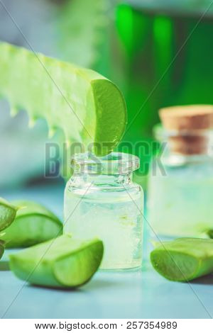Aloe Vera Extract In A Small Bottle And Pieces On The Table. Selective Focus.