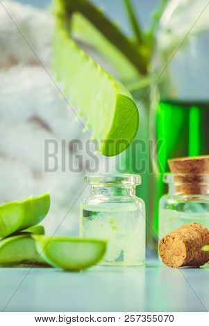 Aloe Vera Extract In A Small Bottle And Pieces On The Table. Selective Focus.