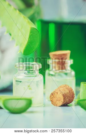 Aloe Vera Extract In A Small Bottle And Pieces On The Table. Selective Focus.