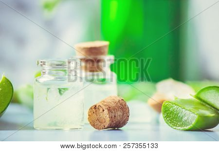 Aloe Vera Extract In A Small Bottle And Pieces On The Table. Selective Focus.