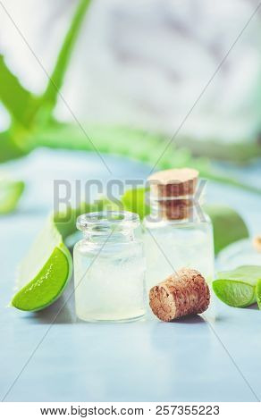 Aloe Vera Extract In A Small Bottle And Pieces On The Table. Selective Focus.