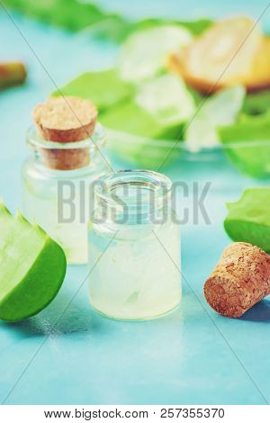 Aloe Vera Extract In A Small Bottle And Pieces On The Table. Selective Focus.