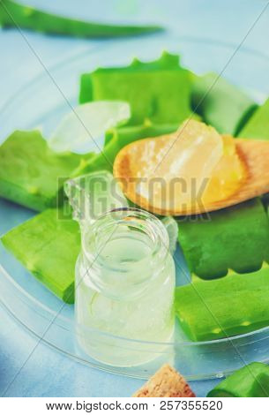 Aloe Vera Extract In A Small Bottle And Pieces On The Table. Selective Focus.