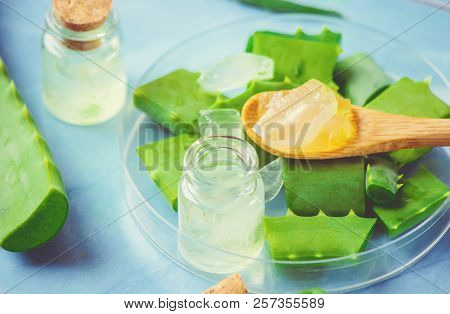 Aloe Vera Extract In A Small Bottle And Pieces On The Table. Selective Focus.