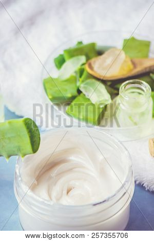 Aloe Vera Extract In A Small Bottle And Pieces On The Table. Selective Focus.