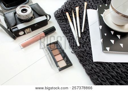 Top View Working Space With Laptop, Old Retro Camera, Cup Of Coffee And Cosmatics For Beauty And Fas
