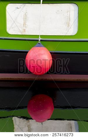 Traditional Dutch Vessel With A Pink Buoy With Reflection In The Water