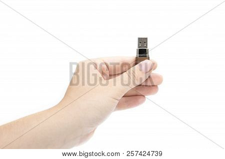 Flash Drive In Woman's Hand On White Background. Female's Hand Holding Flash Drive.