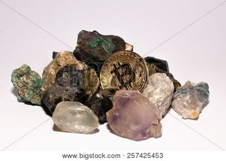Golden Bitcoin Coin Stuck Between Stones. Cryptocurrency Mining Concept, Selective Focus.
