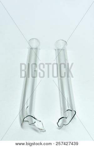Laboratory Drying Tube, U-bent, Broken. Shards On Blue Backgrounds
