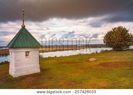 Chapel In Konstantinovo, Moscow Region, Russia. Dramatic Sunset Cloudy Sky And River Oka In Backgrou