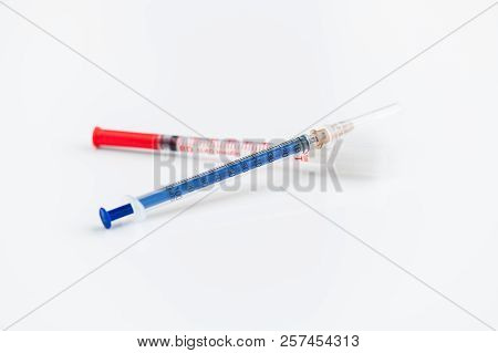 Closeup Shot Of Two Disposable Insulin Syringes Crossed Isolated On White Background, Medicine And T