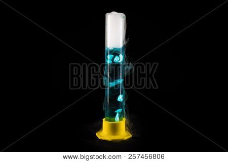 Close Up Of Glass Tube With Blue Liquid With Cold Steam Pouring From It Against Black Background, Ch