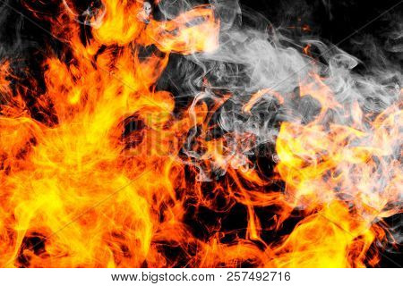 Fire Flames Background. Cloud Of  Fiery Smoke On A Black Isolated Background. Background From The Sm