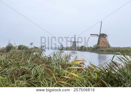 On The Water There Are Several Windmills In Kinderdijk In Holland