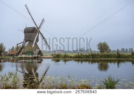 On The Water There Are Several Windmills In Kinderdijk In Holland