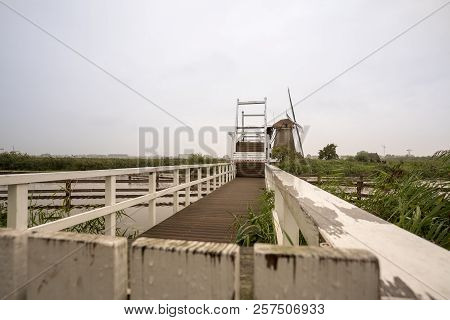 In Kinderdijk In The Netherlands This Beautiful Drawbridge Is Attached To The Windmill