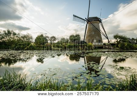 On The Water There Are Several Windmills In Kinderdijk In Holland