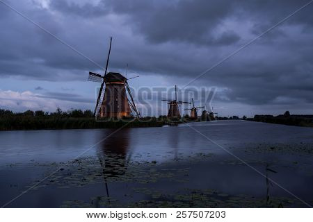 On The Water There Are Several Windmills In Kinderdijk In Holland