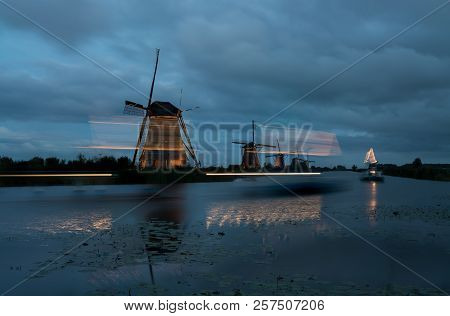 These Beautiful Windmills In Kinderdijk Are Illuminated With White Light At The Blue Hour