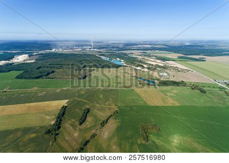 European Plain Landscape, View From A Great Height. In The Distance Are Visible Factories With Smoki