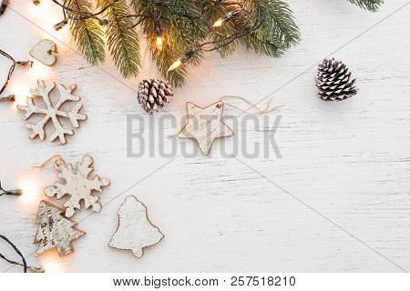 Christmas Background - Fir Leaves And  Rustic Elements Decorating On White Wood Table. Creative Flat