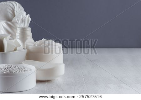 Elegance White Skin Care Cosmetics And Accessories On Wood Table And Dark Grey Wall, Copy Space, Clo
