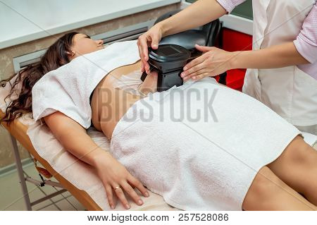 Woman Getting Cryolipolysis Fat Treatment Procedure In Professional Cosmetic Cabinet Or Spa Center