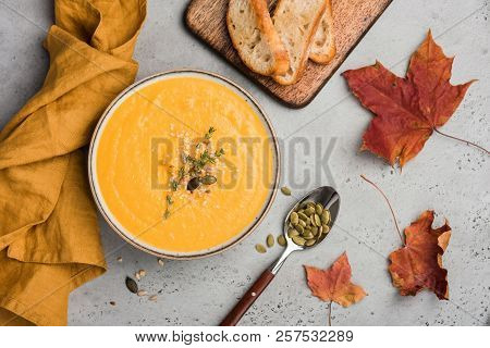 Pumpkin Soup Puree Or Cream Soup In Bowl. Autumn Comfort Food On Concrete Background. Warming Bowl O