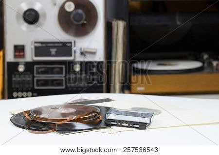 Vinyl Record With Copy Space In Front Of A Collection Albums Dummy Titles. Reel Tape Recorder. Audio