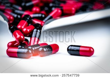 Selective Focus Of Red And Black Capsule Pills On Stainless Steel Drug Tray. Antibiotics Drug Resist