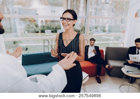 Girl Talking With Arab About Business Partnership. Money Investment. Paper Documents. Business Strat